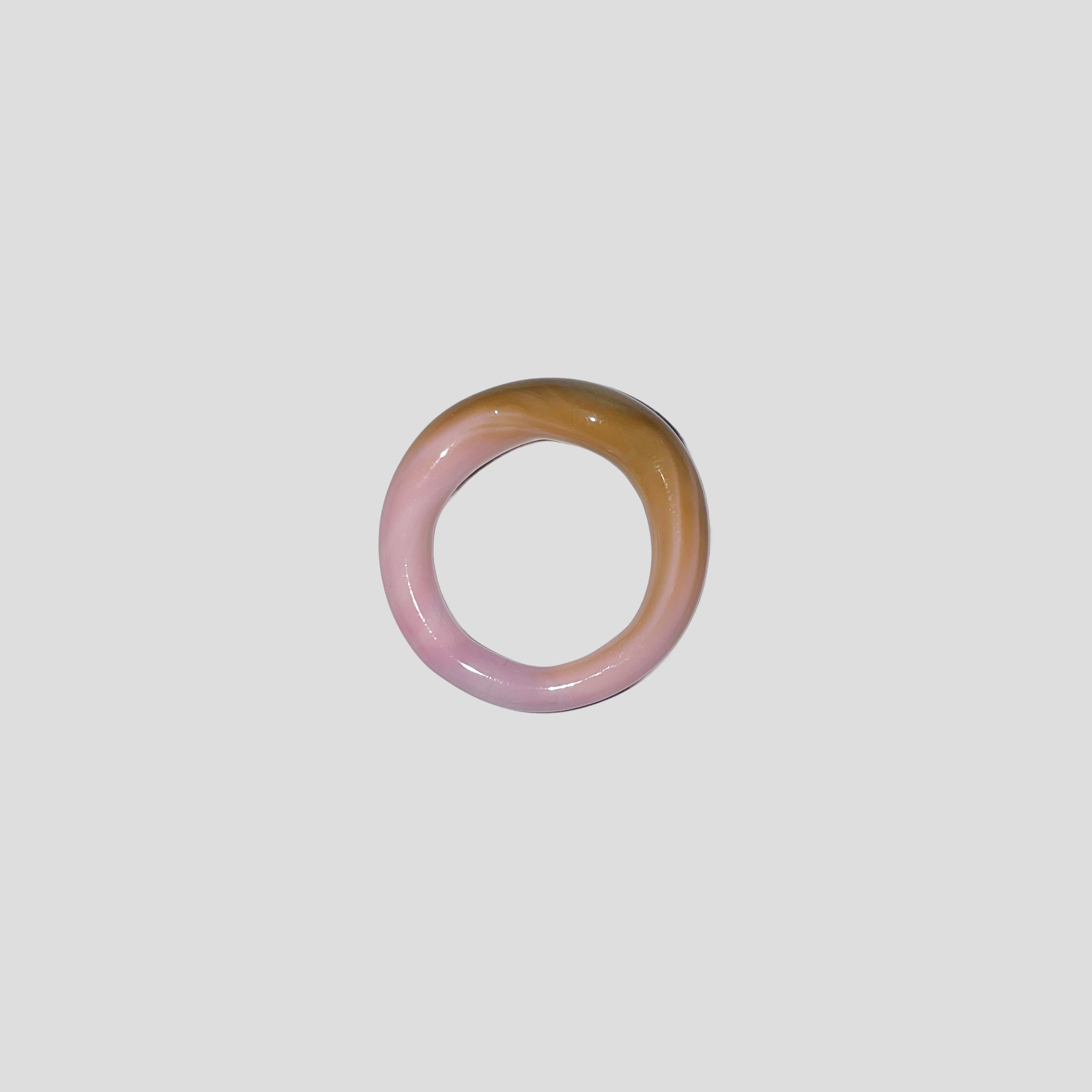 Gradient glass ring with pink and brown colors on a white background. ring is from all rivers jewelry from berlin